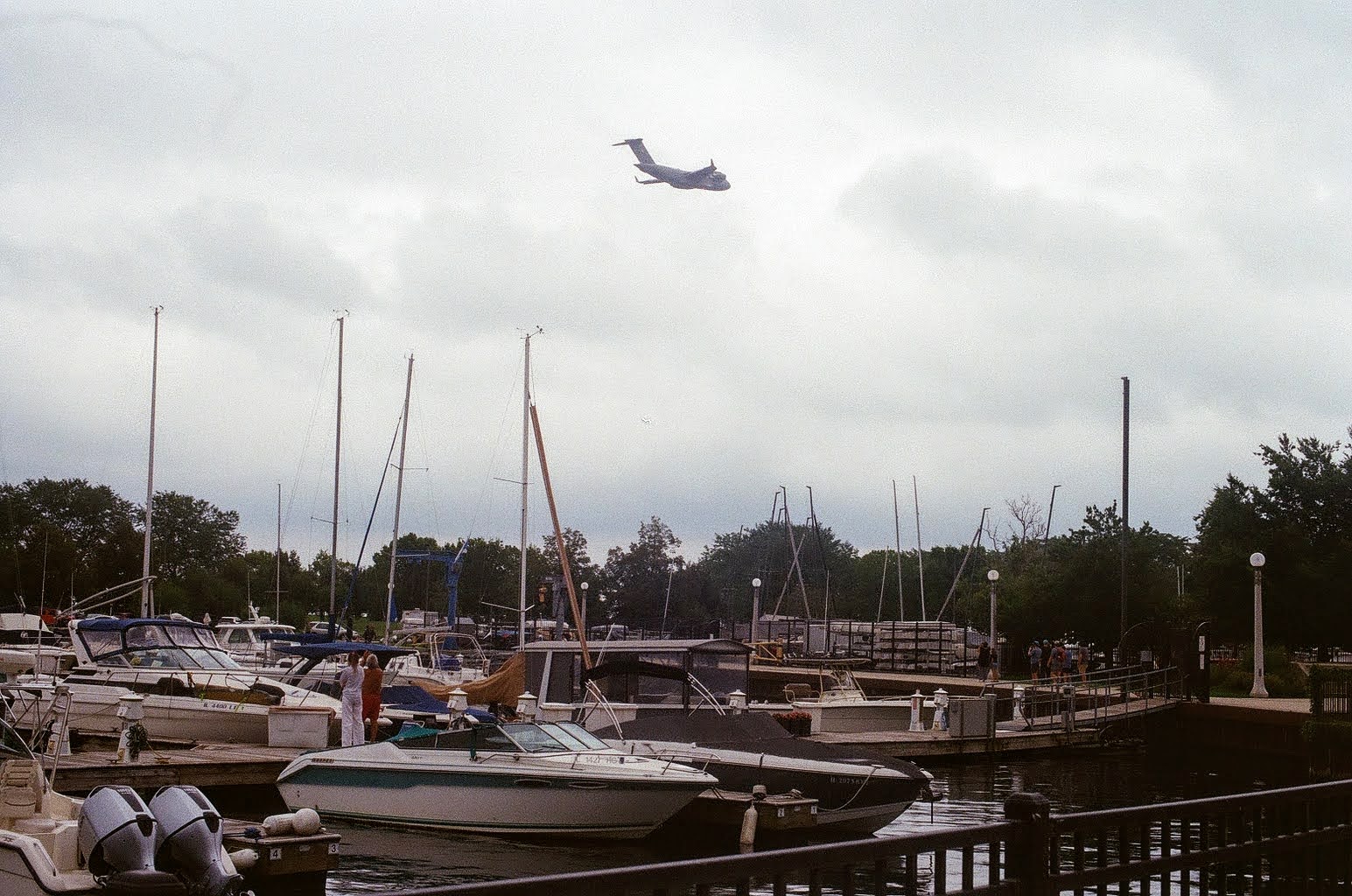Airplane above boats along the Chicago lakefront