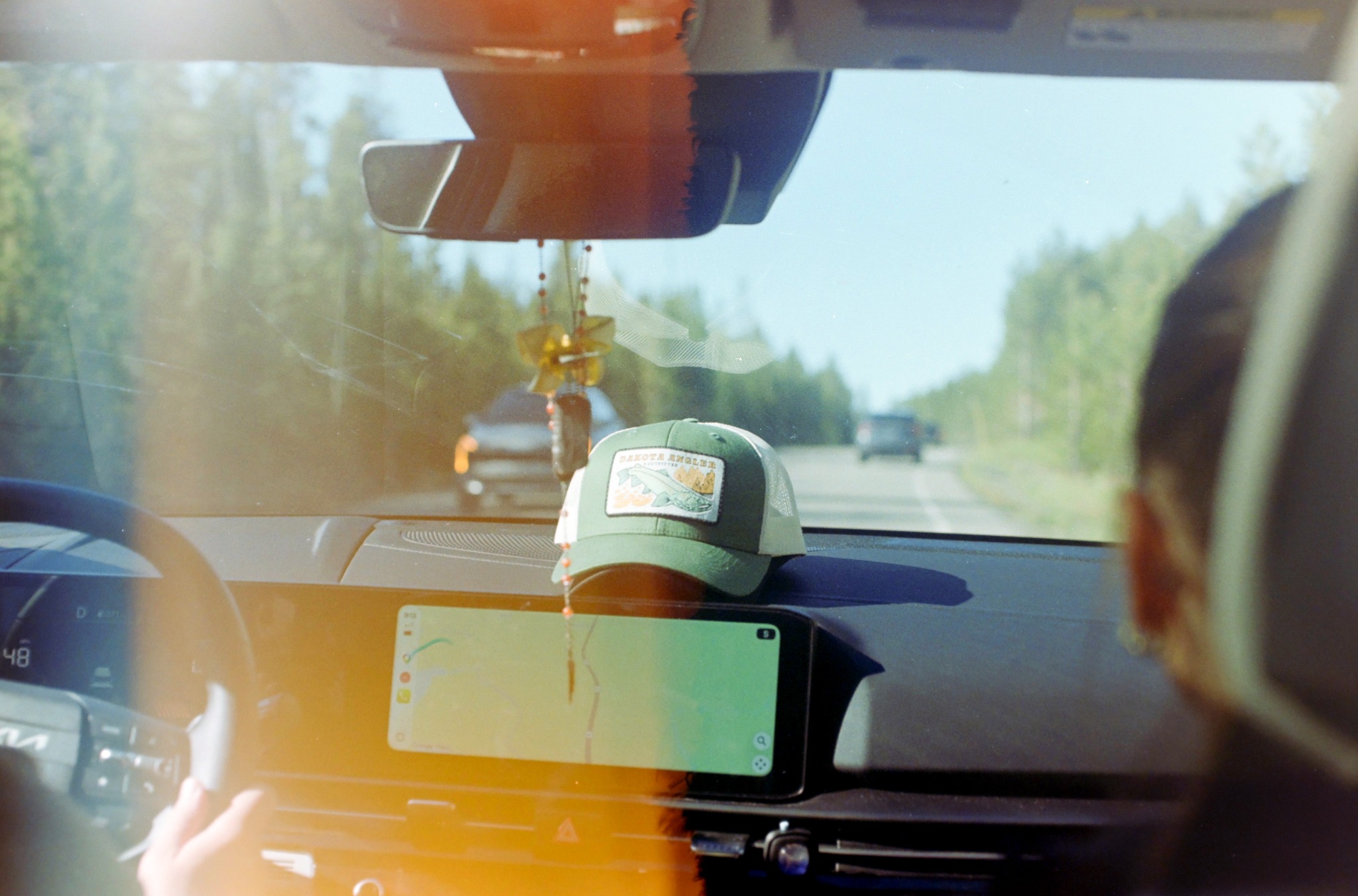 View through a car windshield on a forest road