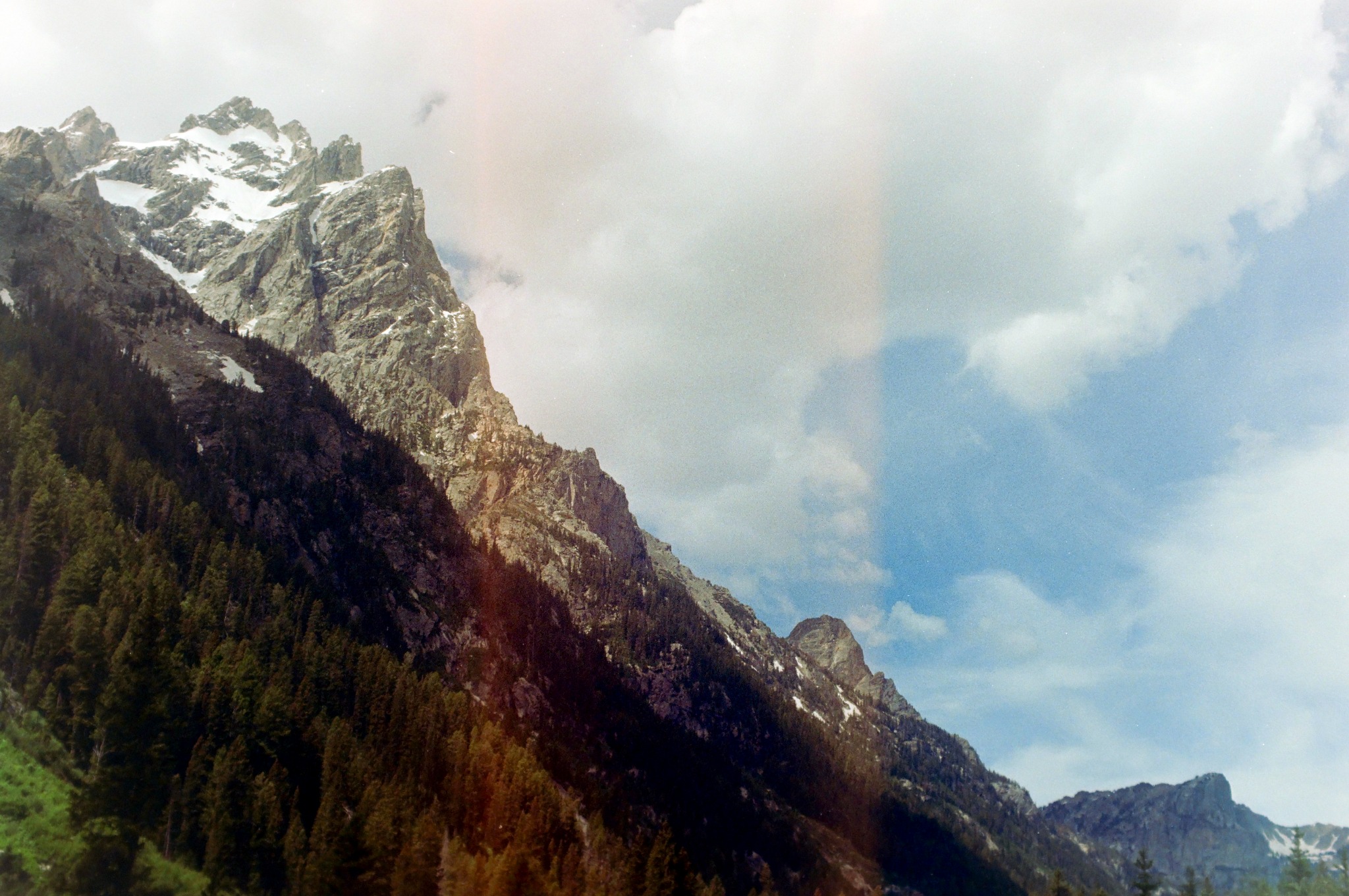 Mountain ridge beneath large clouds